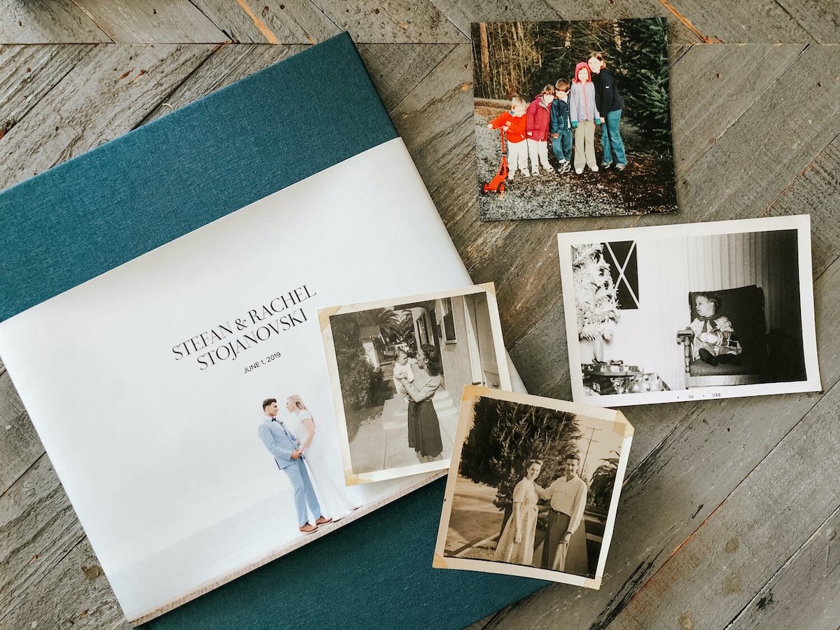 Artifact Uprising Hardcover Wedding Photo Book on coffee table along with various photo prints