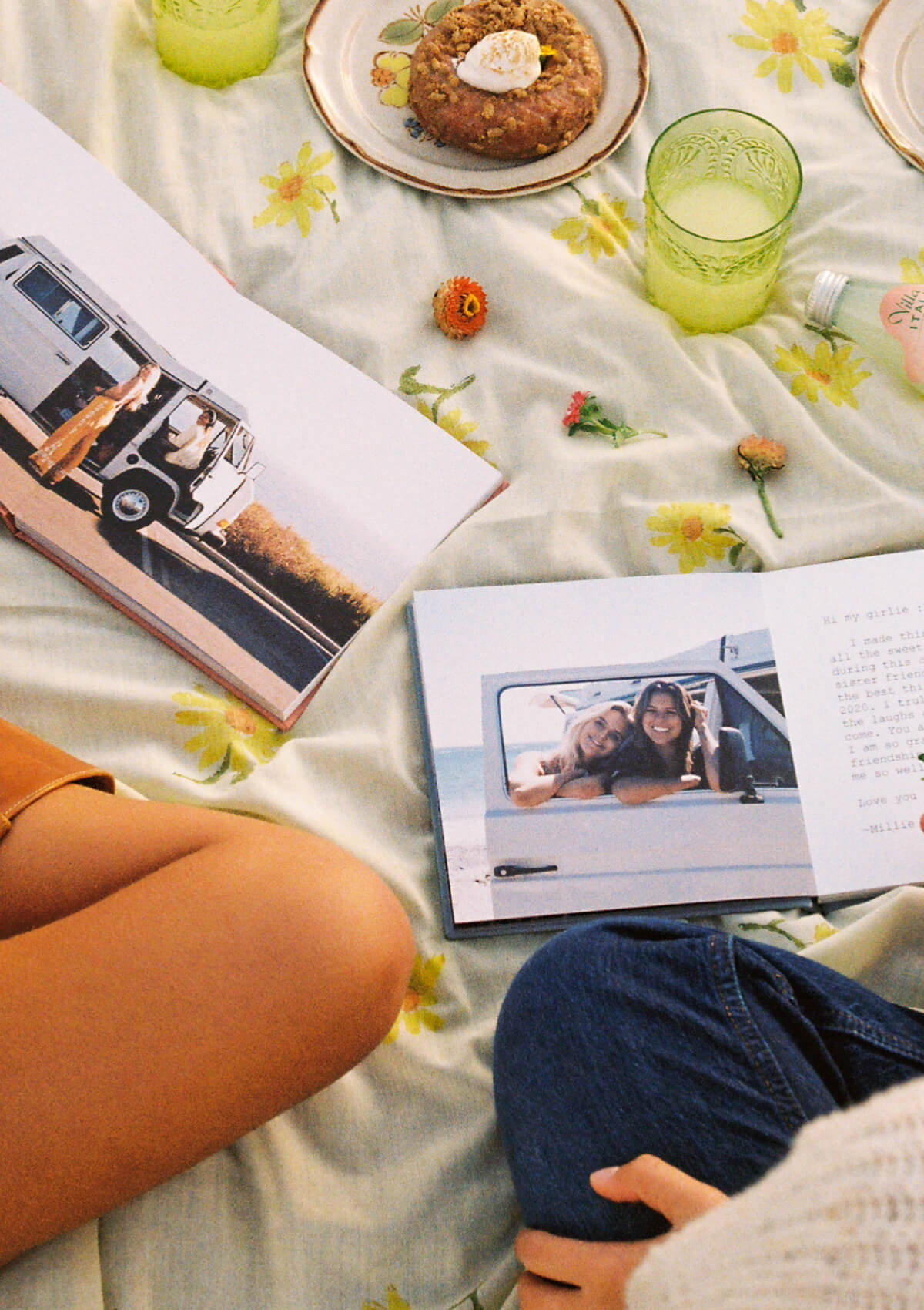 Two people looking inside travel photo books