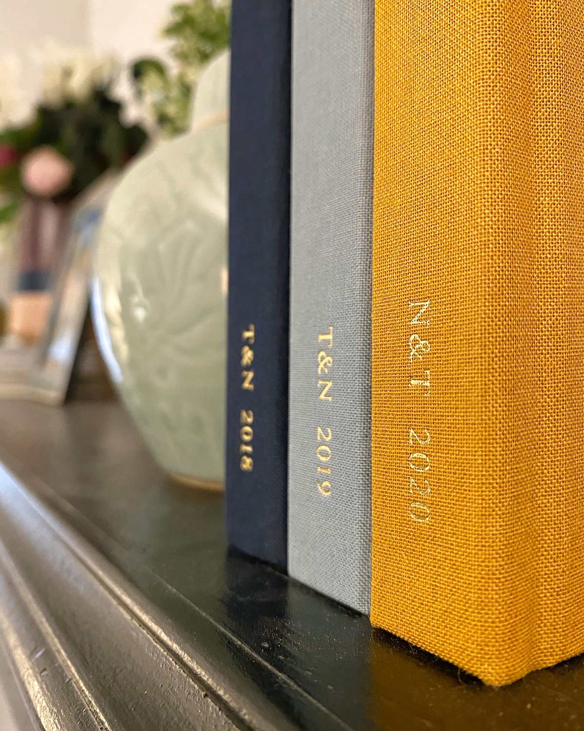 Three consecutive photo yearbooks on a shelf
