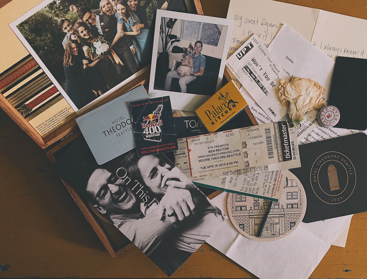 Box with scattered photos, tickets, and sentimental items