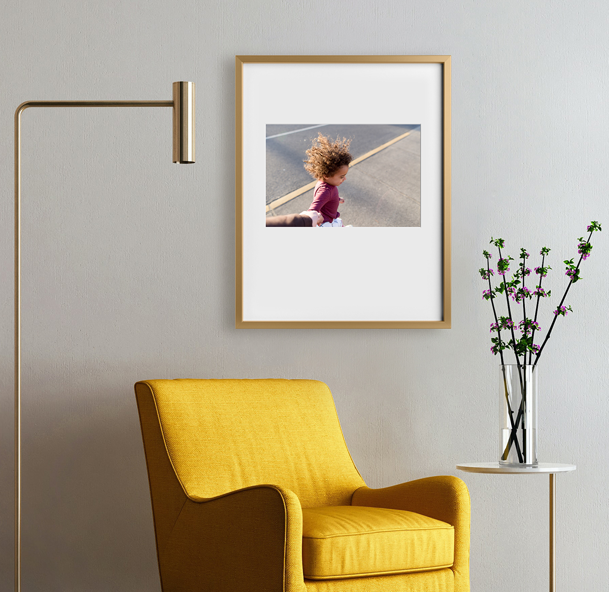 Artifact Uprising Modern Metal Frame featuring prominent mat and photo of little girl hung above honeycomb armchair