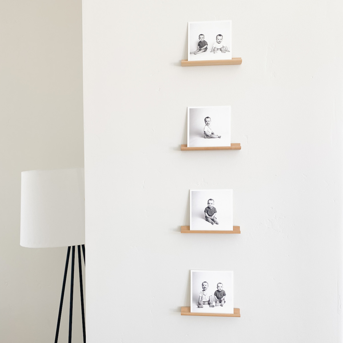 Four small square prints displayed on the wall.