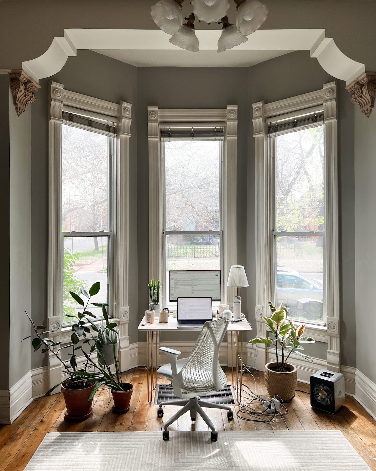 Photo of desk are in old victorian home with light flooding in the windows