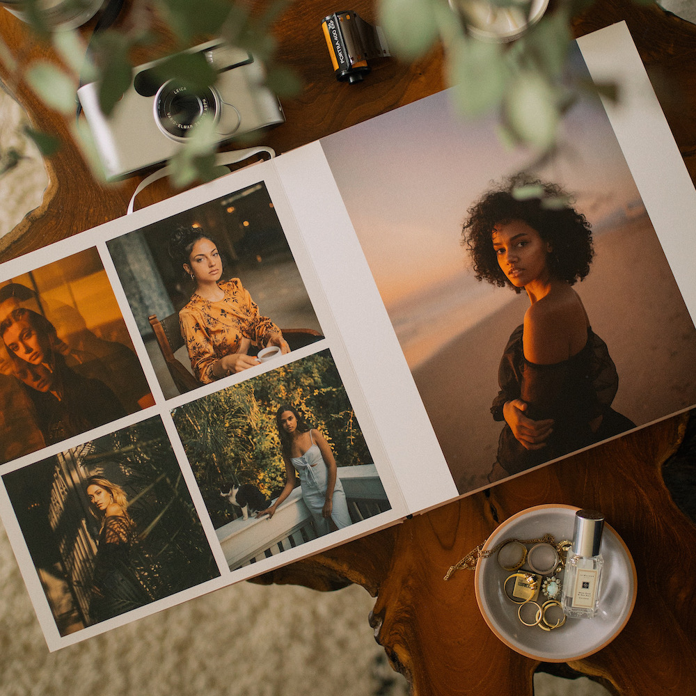 Colorful linen-bound photo books in a woven basket on a shelf.