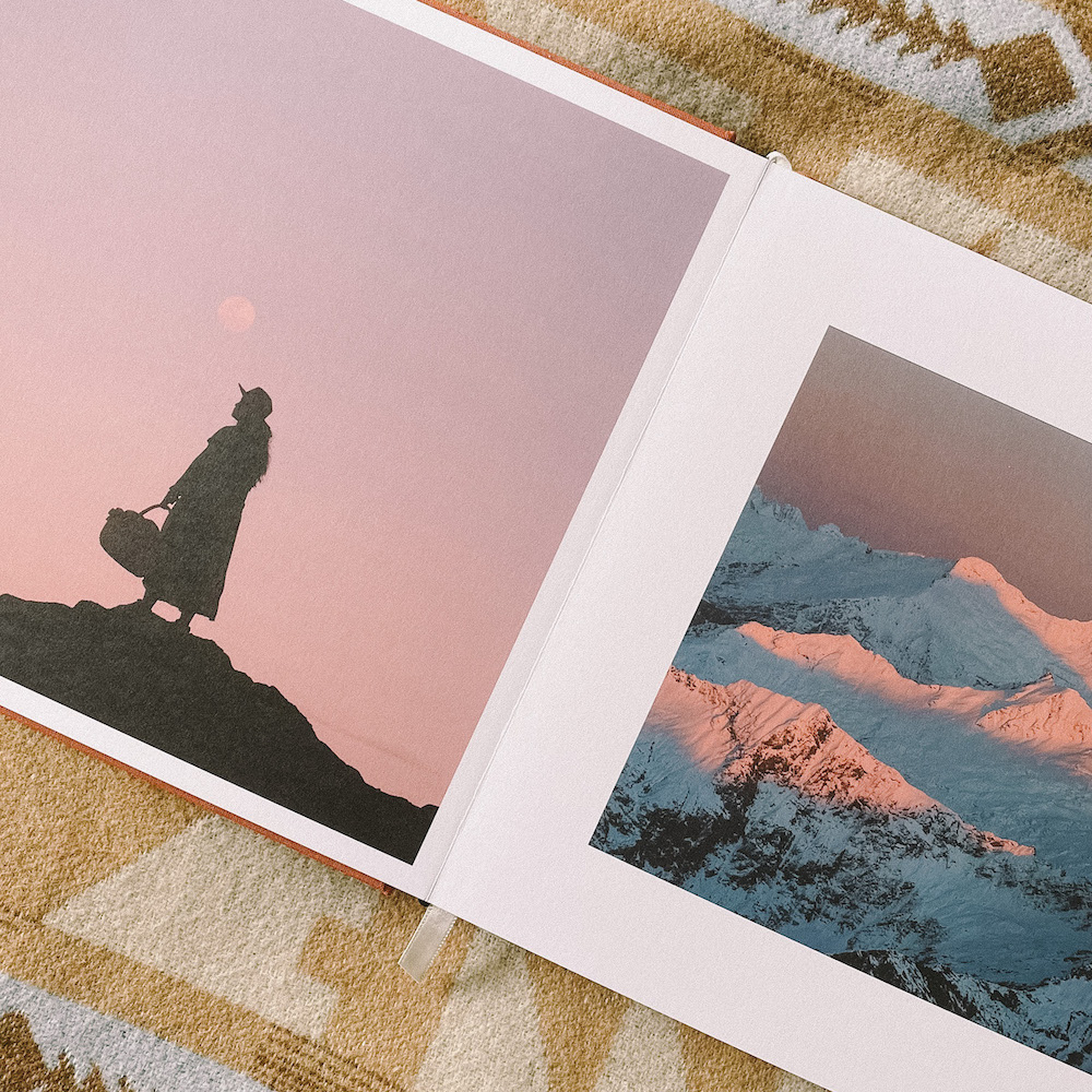 Artifact Uprising Signature Layflat Album opened to two pages of scenic mountain photos
