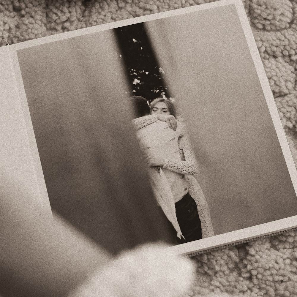 Candid photo of bride embracing father featured in a full page layout of an Artifact Uprising Layflat Photo Album