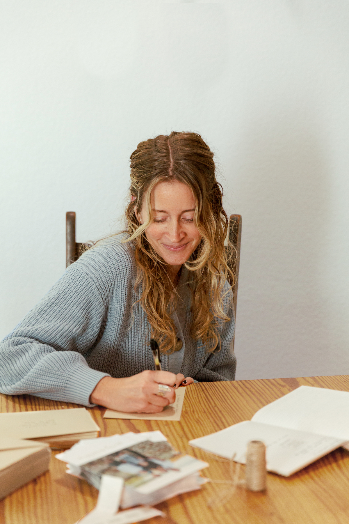 smiling while addressing holiday cards